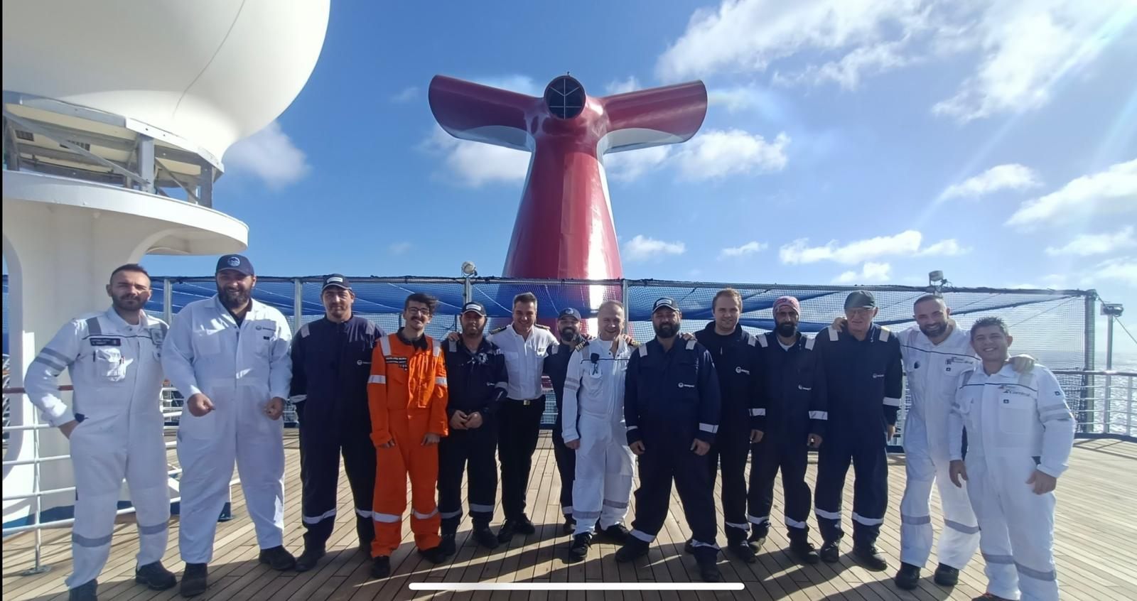 SeaQuest project crew on deck beside a cruise ship funnel