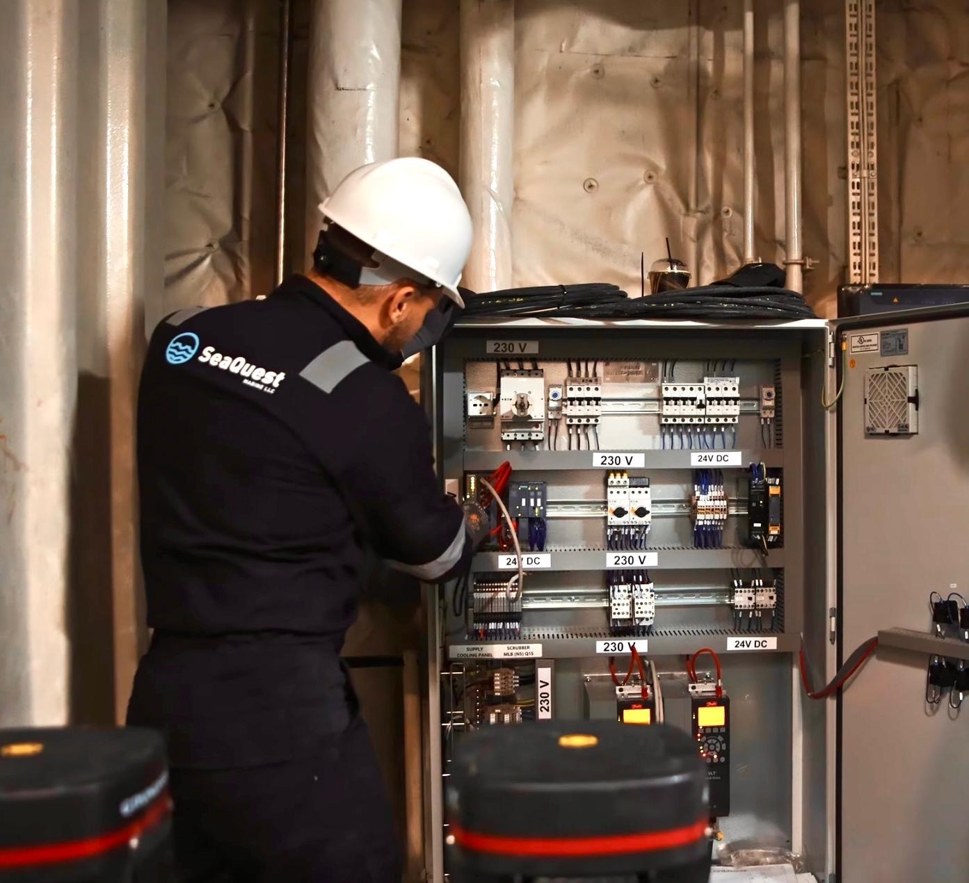 SeaQuest technician servicing a scrubber control panel