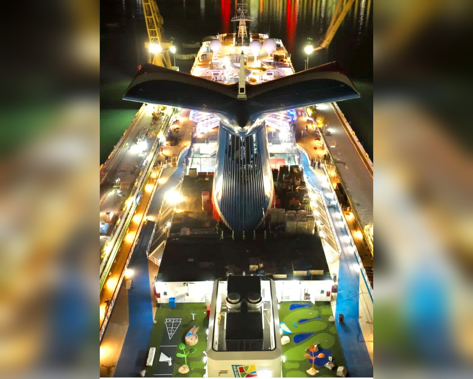 Aerial night view of a cruise vessel's stern wake fins in dry dock